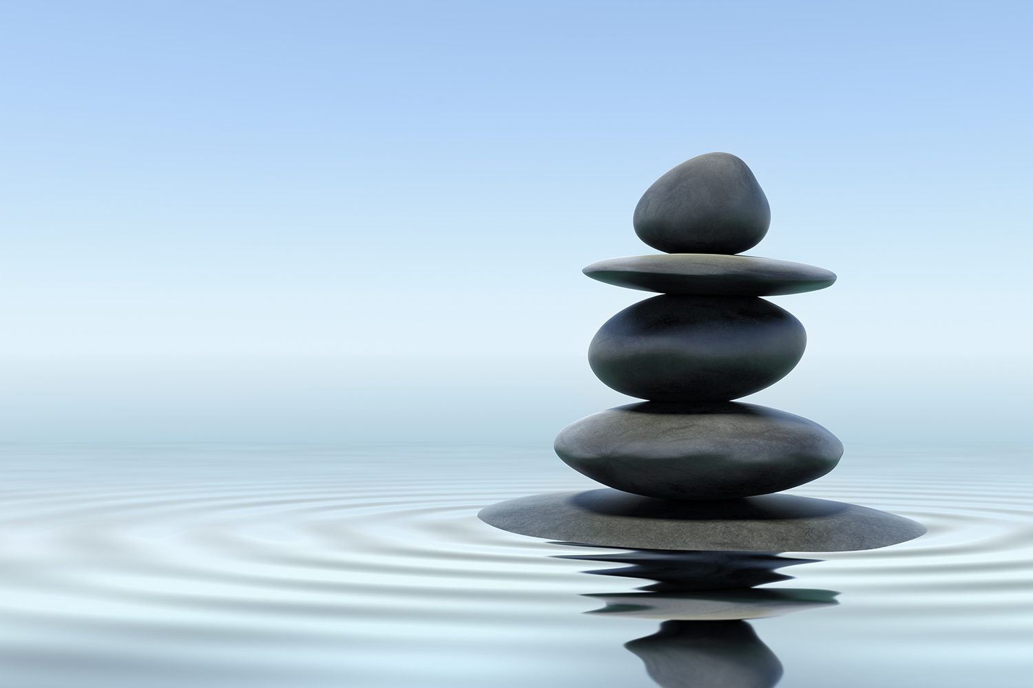 zen standing stones balanced in rippling water