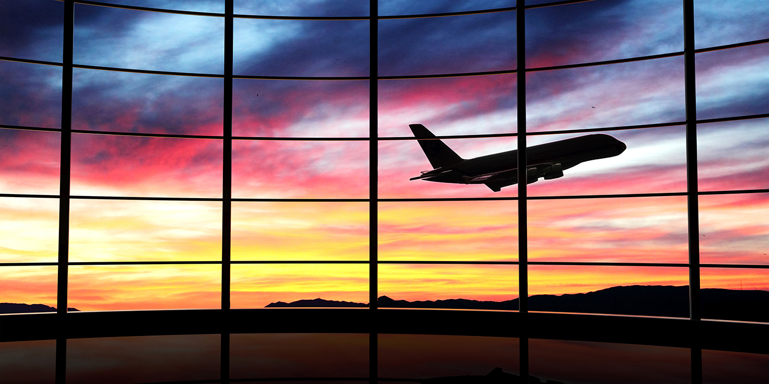 An airplane taking off under a relaxing sunset