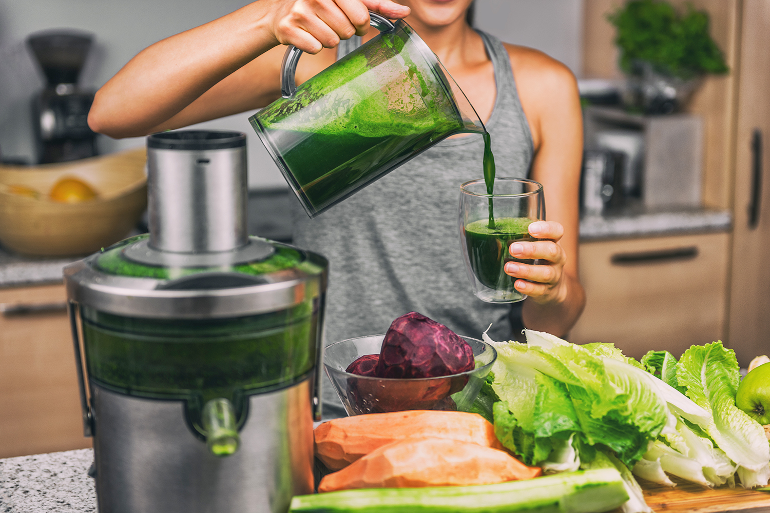 a woman using a juicer