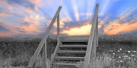 wooden steps leading up to a bright sky