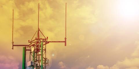 Communication tower or 4G 5G network telephone cellsite with cloudy sky during sunset. 