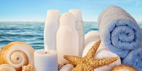 skin moisturizer and other products on the beach