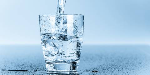 a glass of water being filled