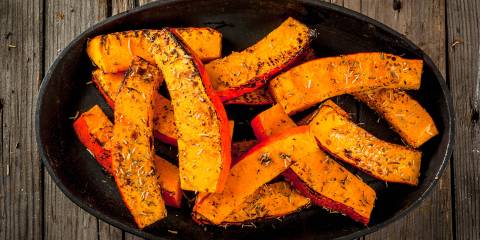 a bowl of seasoned pumpkin wedges