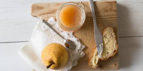 a jar of pear butter with some toast