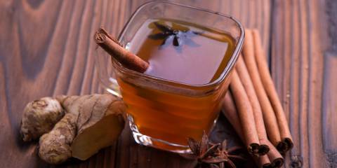 a mug of apple cranberry cider with cinnamon, star anise, and ginger