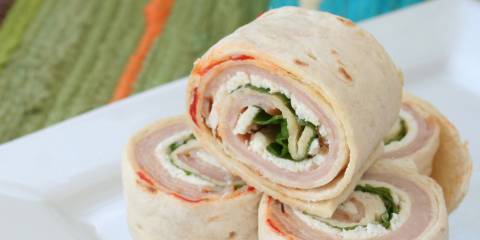 a turkey wrap sliced into four pieces