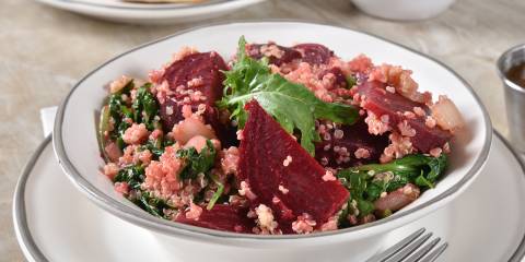 a bowl of quinoa, beets, and leafy greens