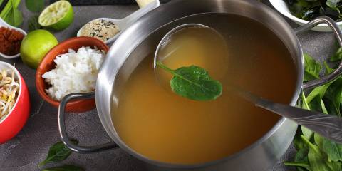 a pot of simmering asian broth