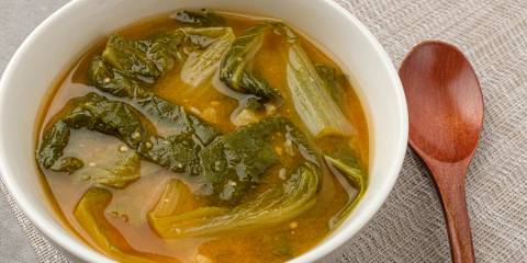 a bowl of miso soup with cabbage