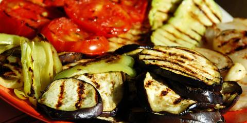 a platter of grilled squash, tomato, and eggplant