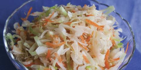 A bowl of cabbage, carrots, and sauerkraut