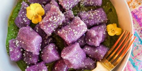 a bowl of cauliflower gnocchi on greens