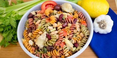 A bowl of three-bean pasta salad with vegetables