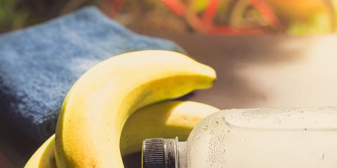  Gym workout accessory close up bottle of cool drinking water and banana.