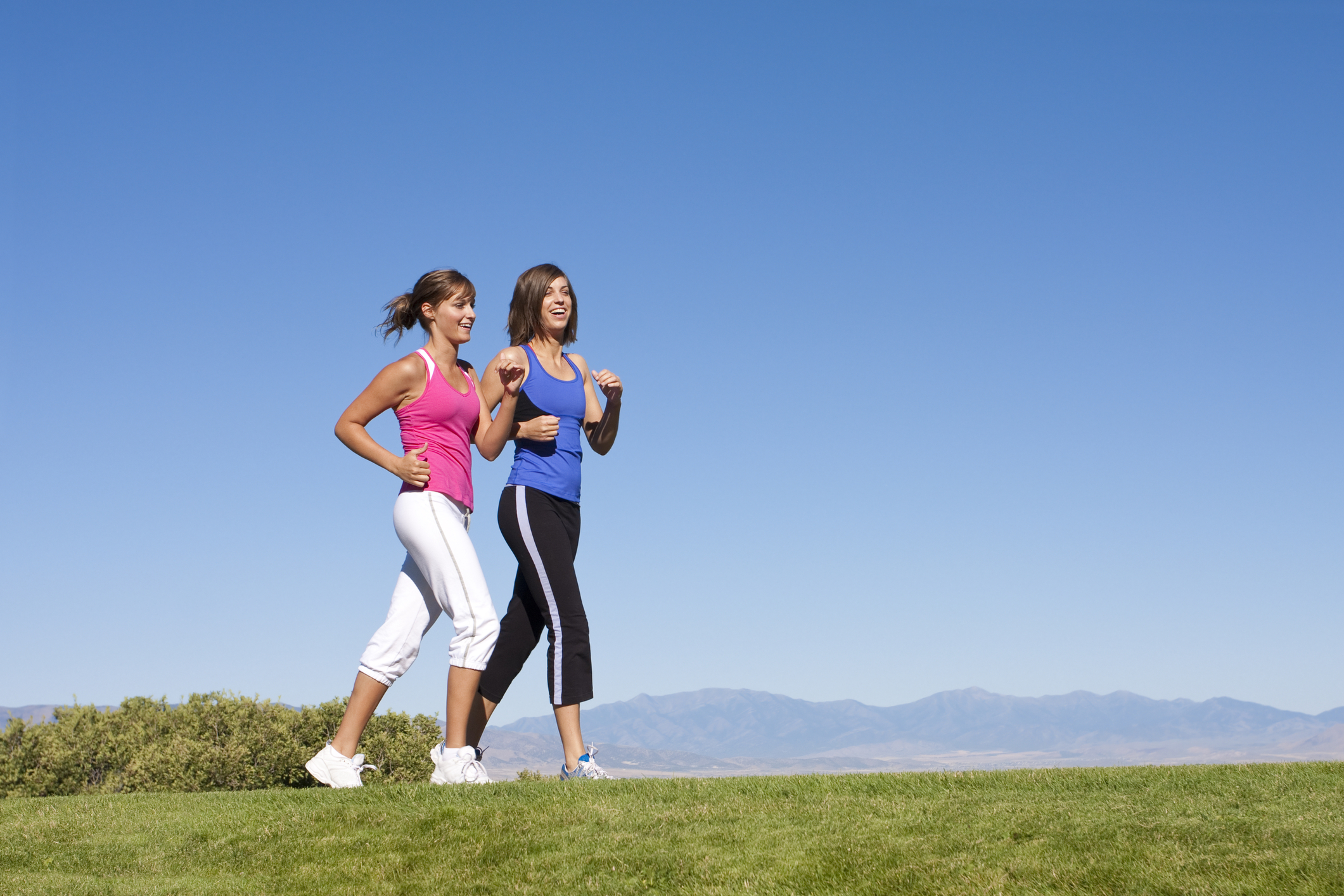 Two women walking together outside. 
